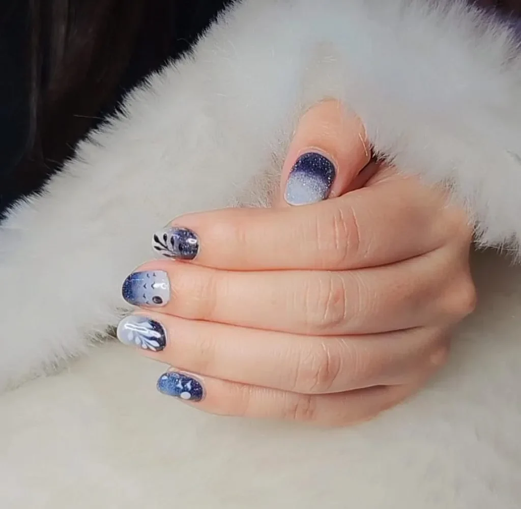 Blue abstract nail art at a premium nail salon in Thrissur with glossy winter manicure style.